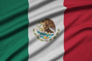 Mexico flag is depicted on a sports cloth fabric with many folds. Sport team waving banner